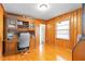 Wood-paneled office with built-in shelves, desk, chair, and natural light from the window at 3140 Westmart Ln, Atlanta, GA 30340