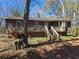 Charming one-story home with wood siding, front porch and stairs leading to the entrance at 6575 Riley Rd, Cumming, GA 30028