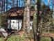 Exterior view of the garage with storage space on a lot filled with trees and natural light at 6575 Riley Rd, Cumming, GA 30028