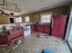 Kitchen featuring a red fridge, stainless steel double basin sink, and windows at 6575 Riley Rd, Cumming, GA 30028