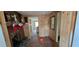 Living room with a fireplace, and wood paneling, showing a view into the next room at 6575 Riley Rd, Cumming, GA 30028