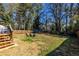 Large fenced backyard, mature trees, and a charming fire pit area perfect for outdoor gatherings at 2174 Juanita St, Decatur, GA 30032