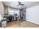 Bright office space with painted brick accent wall, wood floors, shelving, and windows providing natural light at 2174 Juanita St, Decatur, GA 30032