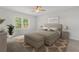 Serene bedroom with a padded headboard, bench seat, and a large window offering natural light at 237 Kindness Cir, Mcdonough, GA 30252