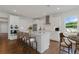 Bright kitchen features white cabinetry, stainless steel appliances, and a large island with bar seating at 237 Kindness Cir, Mcdonough, GA 30252