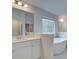 Bright bathroom featuring a standalone soaking tub and vanity sink at 308 Moab Ct, Stockbridge, GA 30281