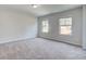 Spacious bedroom with neutral carpet and two bright windows, offering a serene retreat at 308 Moab Ct, Stockbridge, GA 30281