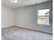 Bright bedroom features a large window and plush carpeting at 308 Moab Ct, Stockbridge, GA 30281