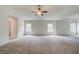 Spacious bedroom featuring neutral carpet, multiple windows, and a ceiling fan at 308 Moab Ct, Stockbridge, GA 30281