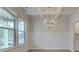 Elegant dining room featuring decorative trim, hardwood floors, and a stylish light fixture at 308 Moab Ct, Stockbridge, GA 30281