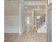Inviting entryway with light wood floors, staircase with iron spindles, and decorative wall paneling at 308 Moab Ct, Stockbridge, GA 30281