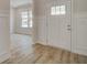 Bright entryway showcasing hardwood floors, decorative wall paneling, and a stylish front door at 308 Moab Ct, Stockbridge, GA 30281