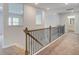 Second floor hallway with iron and wood banister with view into bathroom at 308 Moab Ct, Stockbridge, GA 30281