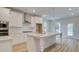 Modern kitchen featuring white cabinets, stainless steel appliances, and a large center island at 308 Moab Ct, Stockbridge, GA 30281