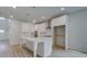 Spacious kitchen featuring a large island, white cabinetry, and stainless steel appliances at 308 Moab Ct, Stockbridge, GA 30281