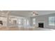 Bright and airy living room features wood floors, a fireplace, and an open layout to the kitchen at 308 Moab Ct, Stockbridge, GA 30281