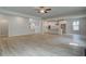 Expansive open-concept living area showcasing wood floors, and a view into the kitchen at 308 Moab Ct, Stockbridge, GA 30281