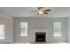 Spacious living room with fireplace, ceiling fan, wood floors and open layout at 308 Moab Ct, Stockbridge, GA 30281