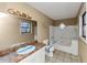 Bright bathroom featuring a vanity, mirror, window and a shower/tub at 6404 Eastbriar Dr, Lithonia, GA 30058
