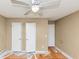 Bedroom with ceiling fan, two closets, and fresh paint on the walls at 6404 Eastbriar Dr, Lithonia, GA 30058