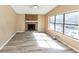 Sunlit living room with a stone fireplace and large windows at 6404 Eastbriar Dr, Lithonia, GA 30058