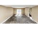 Room featuring neutral paint and trim with access to patio at 6404 Eastbriar Dr, Lithonia, GA 30058