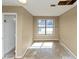 Spacious room with large window, neutral paint, and ceiling damage at 6404 Eastbriar Dr, Lithonia, GA 30058