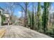 Spacious wooden deck with mature trees provides an outdoor living space at 1038 Orlando Sw Pl, Atlanta, GA 30311