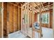 Bathroom framing showing exposed studs, a rough-in shower base and unfinished features at 1038 Orlando Sw Pl, Atlanta, GA 30311