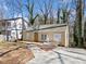 Exterior view of a home under construction showing a newly built deck and freshly poured concrete driveway at 1038 Orlando Sw Pl, Atlanta, GA 30311