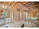 Interior framing of a room showing exposed studs, new window framing and unfinished floor at 1038 Orlando Sw Pl, Atlanta, GA 30311