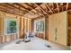 Interior view with exposed framing, showcasing new windows and wood panelling and an unfinished floor at 1038 Orlando Sw Pl, Atlanta, GA 30311