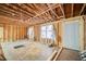 Inside a room with exposed wood framing, featuring an unfinished ceiling and freshly installed door at 1038 Orlando Sw Pl, Atlanta, GA 30311