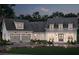 Elegant two-story home at dusk, showcasing a two-car garage and a welcoming covered front porch, exuding warmth and sophistication at 221 Valley Ridge Dr, Carrollton, GA 30116