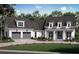 Charming two-story home with a symmetrical design, featuring a two-car garage and covered front porch, set in a landscaped yard at 221 Valley Ridge Dr, Carrollton, GA 30116