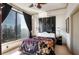 Bright bedroom featuring cityscape views and a decorative ceiling fan at 3445 Stratford Ne Rd # 2305, Atlanta, GA 30326