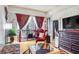 Inviting living room with hardwood floors, balcony access, and a decorative chair at 3445 Stratford Ne Rd # 2305, Atlanta, GA 30326