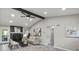 Cozy living room featuring a stone fireplace, wood-look floors, and an exposed beam at 4983 Needle Knob Ct, Lithonia, GA 30038