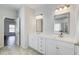 Bathroom featuring dual sinks, quartz countertops, and modern fixtures at 12 Saint Georges Pl, Sharpsburg, GA 30277