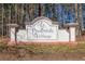 Entrance sign to Parkside Village with flowers and trees at 12 Saint Georges Pl, Sharpsburg, GA 30277