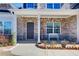 Inviting front porch with brick accents and a cozy bench, creating a welcoming entrance to the home at 12 Saint Georges Pl, Sharpsburg, GA 30277