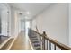 Upstairs hallway with wood floors, recessed lighting, and views into other rooms at 12 Saint Georges Pl, Sharpsburg, GA 30277