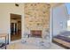 Outdoor fireplace made of stone with an adjacent door and a clear view into the kitchen at 12 Saint Georges Pl, Sharpsburg, GA 30277