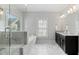 Elegant bathroom with soaking tub, walk-in shower with glass door, and double vanity sink at 1918 Coal Pl, Atlanta, GA 30318