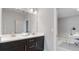 Modern bathroom featuring double sink vanity, dark cabinets and a view to another room at 1918 Coal Pl, Atlanta, GA 30318