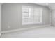 Spacious room with large window, base trim, and carpeting at 1918 Coal Pl, Atlanta, GA 30318