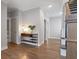 Inviting hallway featuring beautiful hardwood floors and decorative table with flowers at 1918 Coal Pl, Atlanta, GA 30318