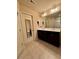 Bathroom features a double sink vanity, tile floors, large mirror, and neutral color palette at 6642 Story Circle Cir, Norcross, GA 30093