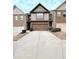 Townhome exterior showcasing a two-car garage, neutral siding, and landscaping at 6642 Story Circle Cir, Norcross, GA 30093