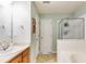 Bathroom featuring a single vanity, large mirror, and walk in shower at 820 Ash St, Canton, GA 30114